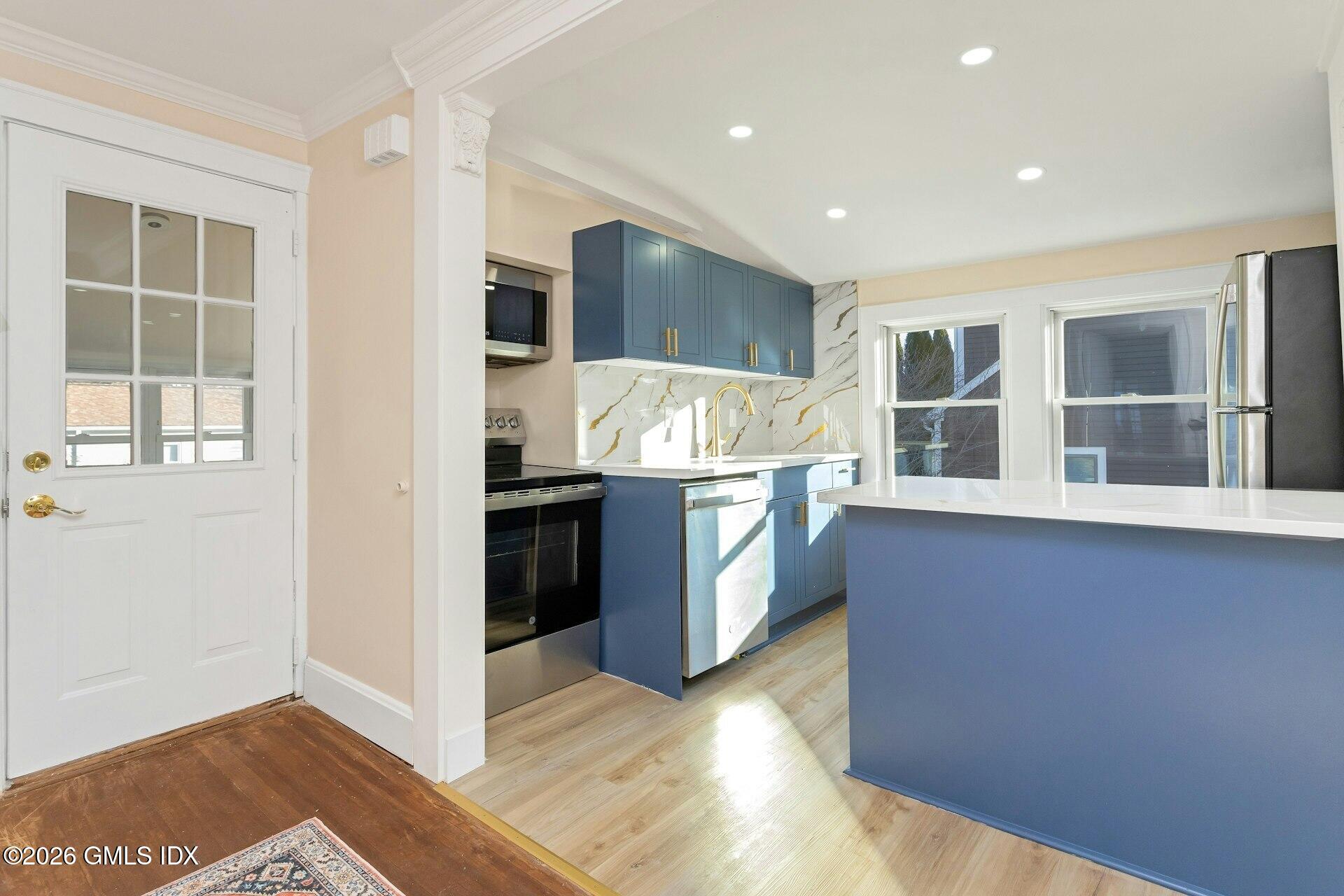 71 Prospect Street, Unit 2 Greenwich, CT 06830 - Photo 6 of 17 a kitchen with stainless steel appliances granite countertop a stove and a refrigerator