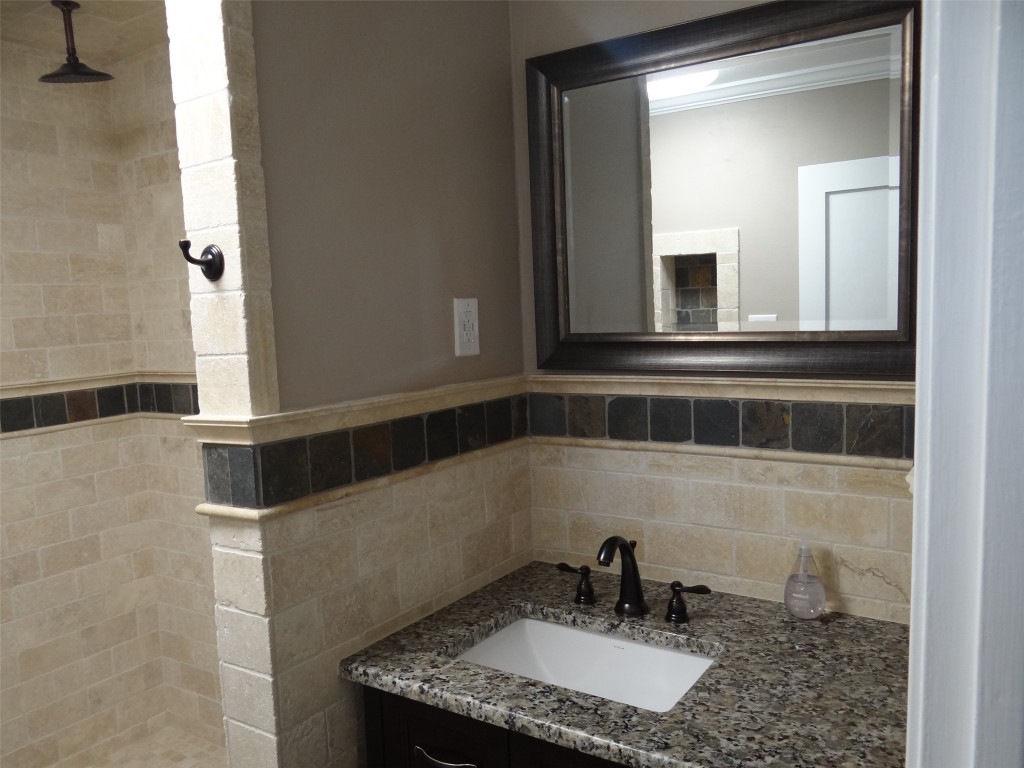 912 East 32nd Street, Unit 103 Austin, TX 78705 - Photo 19 of 27 a bathroom with a granite countertop sink and a mirror