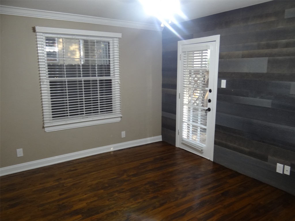912 East 32nd Street, Unit 103 Austin, TX 78705 - Photo 22 of 27 a view of an empty room with wooden floor and a window
