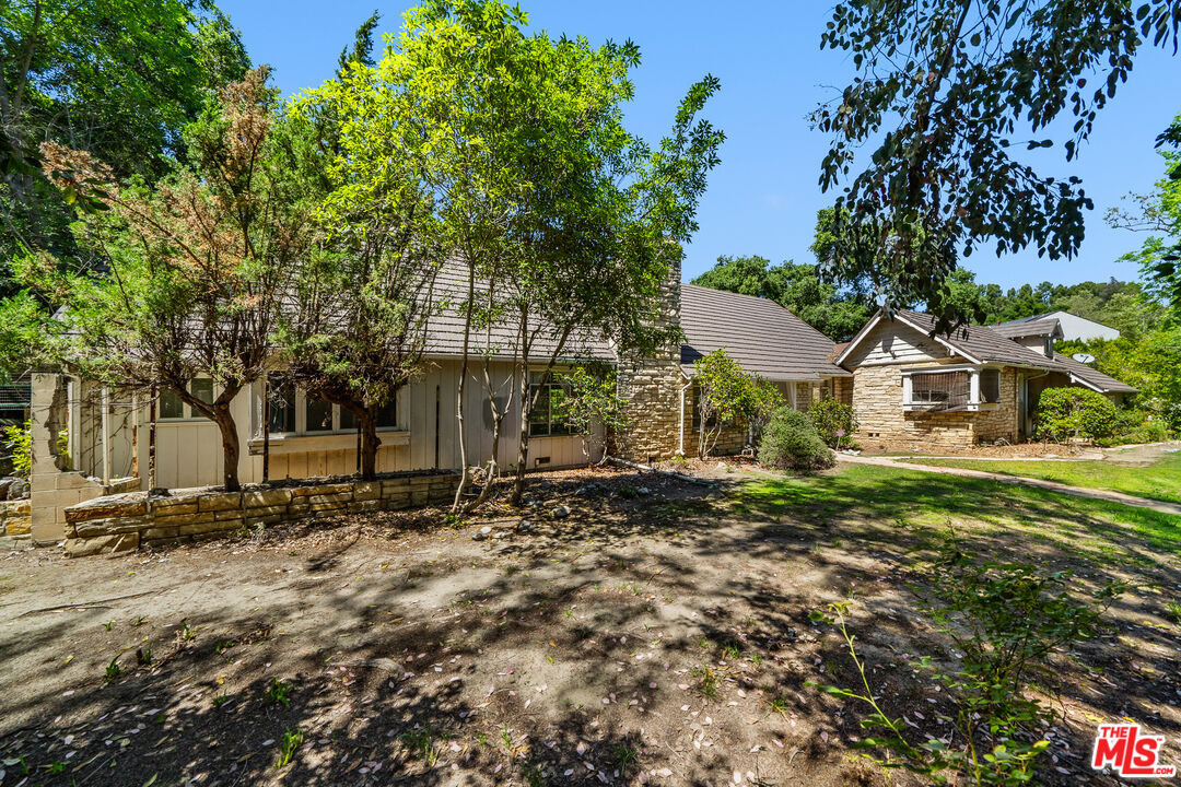 16055 Woodvale Road Encino, CA 91436 - Photo 4 of 5 a view of a house with a yard