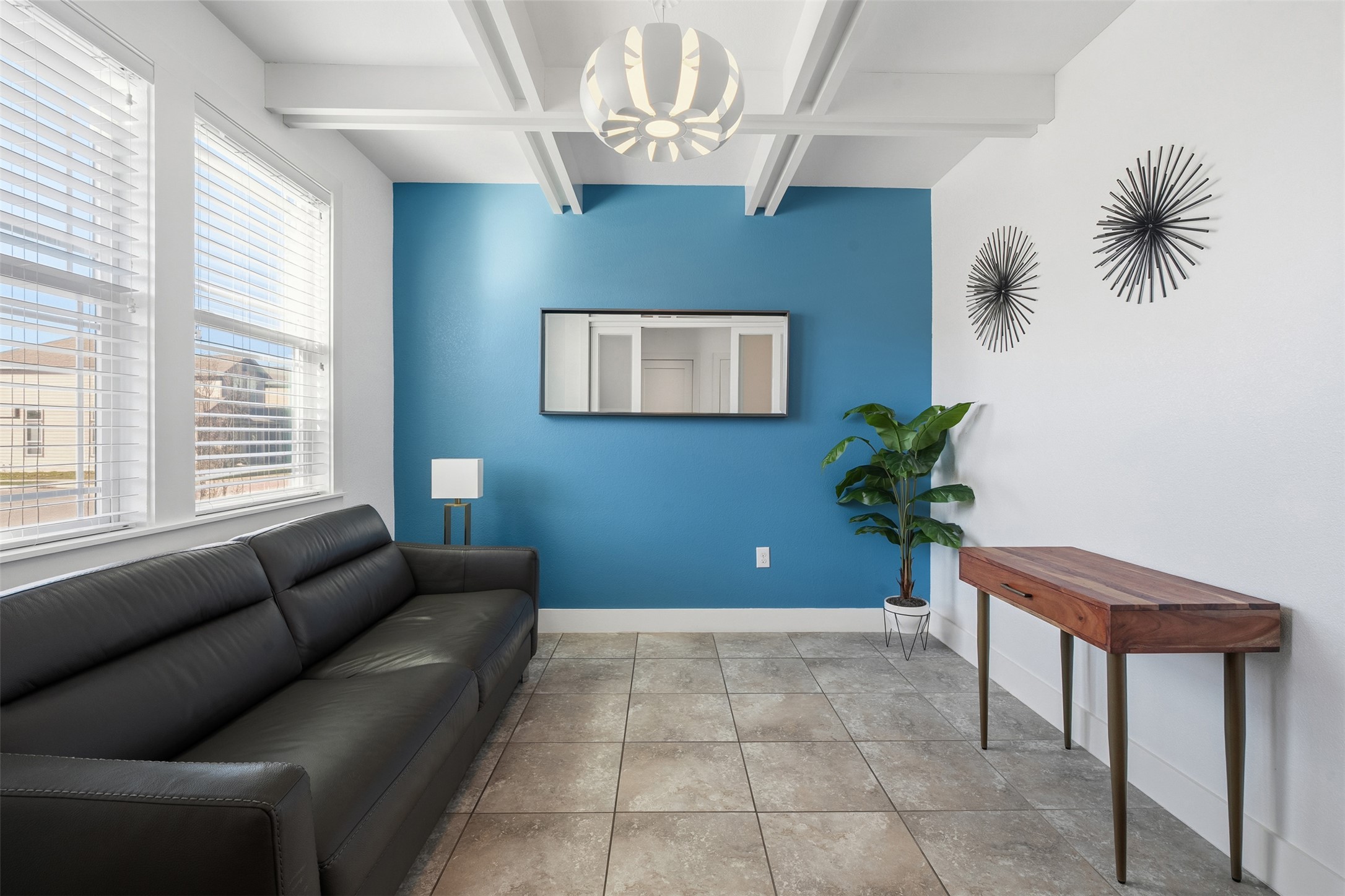 a living room with furniture and a potted plant