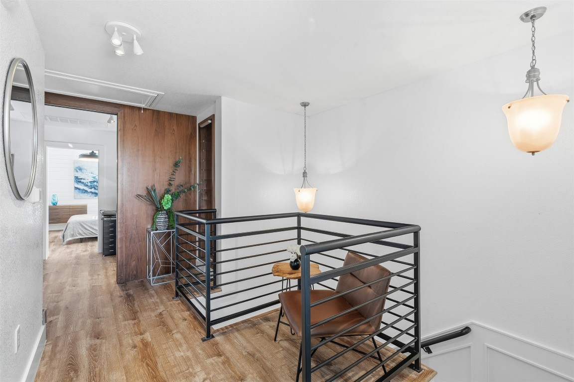 404 Cane River Road Pflugerville, TX 78660 - Photo 11 of 24 a view of a hallway with wooden floor and furniture