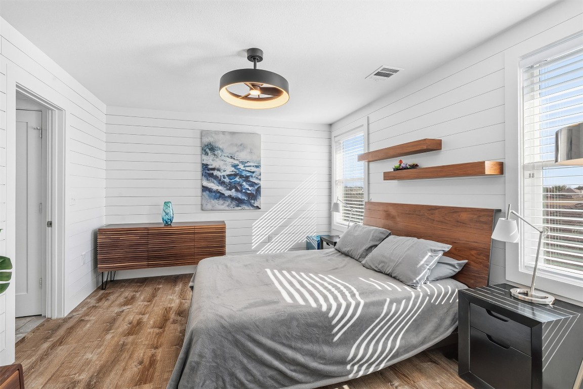 404 Cane River Road Pflugerville, TX 78660 - Photo 13 of 24 a bedroom with a bed and a chandelier