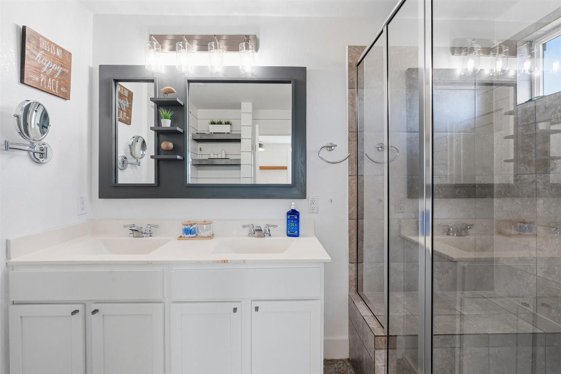404 Cane River Road Pflugerville, TX 78660 - Photo 14 of 24 a bathroom with a sink and a mirror