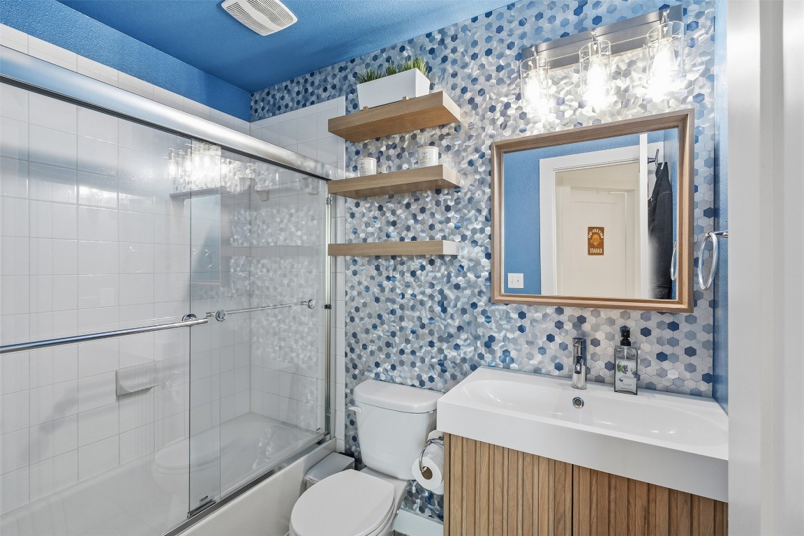 404 Cane River Road Pflugerville, TX 78660 - Photo 17 of 24 a bathroom with a toilet and a shower