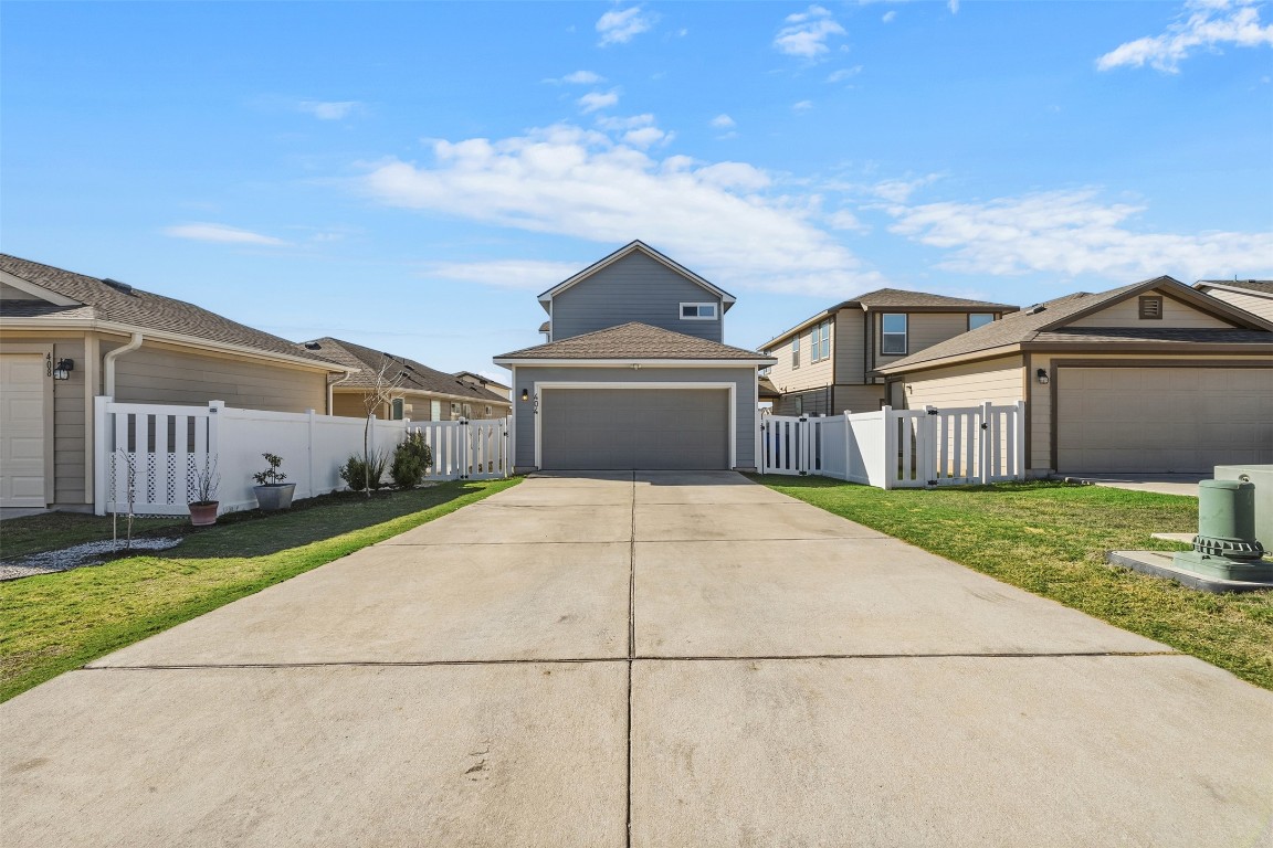 404 Cane River Road Pflugerville, TX 78660 - Photo 21 of 24 a front view of a house with a garden and yard