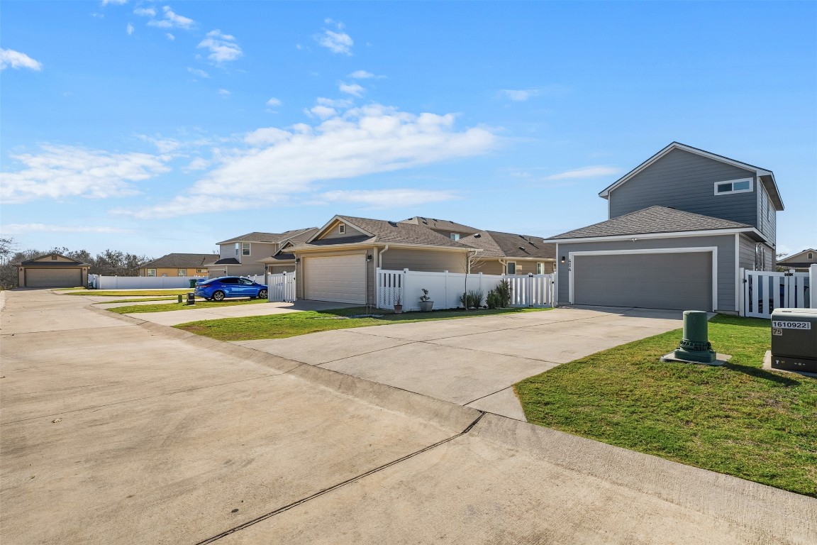 404 Cane River Road Pflugerville, TX 78660 - Photo 22 of 24 a view of a house with swimming pool and a yard