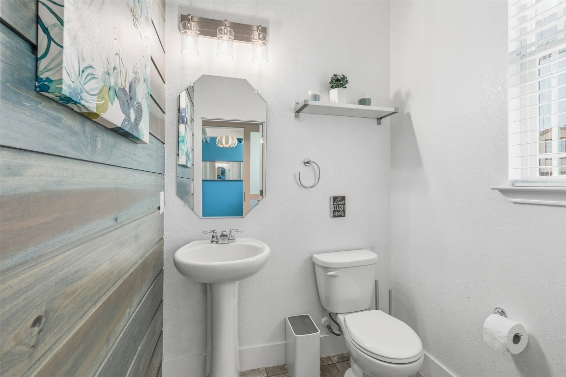 404 Cane River Road Pflugerville, TX 78660 - Photo 5 of 24 a bathroom with a sink a toilet and mirror