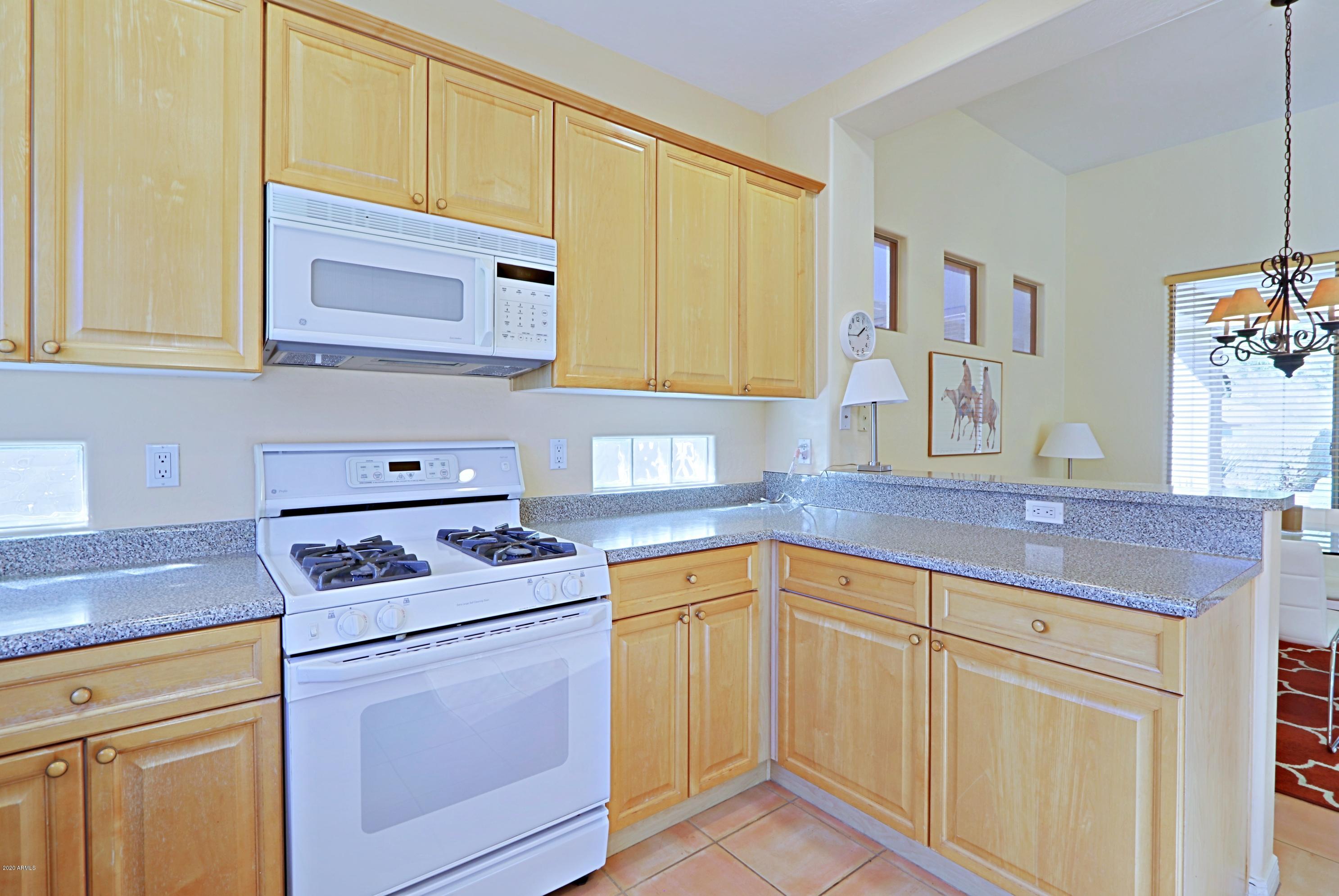 6803 East Eagle Feather Road Scottsdale, AZ 85266 - Photo 10 of 67 a kitchen with a sink stove and cabinets
