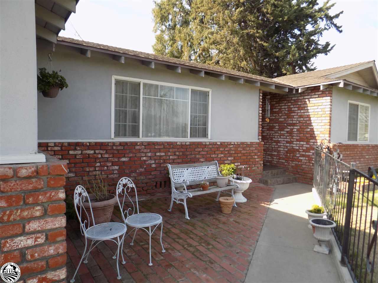 4407 Mountain View Road Hughson, CA 95326 - Photo 6 of 11 a view of a patio with table and chairs with wooden floor and fence