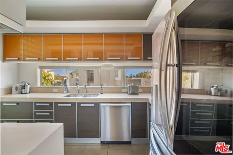 a kitchen with stainless steel appliances granite countertop a stove and a refrigerator