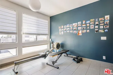 a room with gym equipment and a window