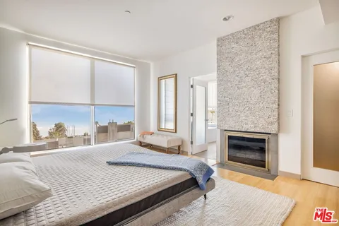 a bedroom with a bed and a fireplace