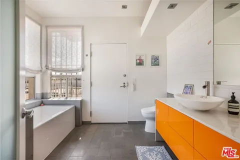 a large white room with a large window and sink