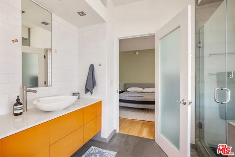 a en suite bathroom with a tub sink and mirror