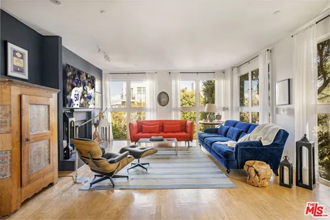 a living room with furniture rug and wooden floor