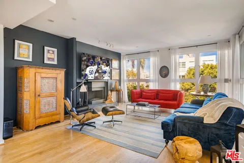 a living room with furniture and floor to ceiling window