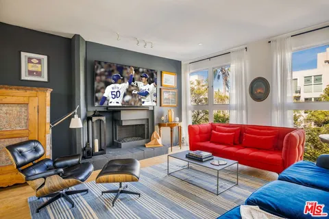 a living room with furniture a rug and a window