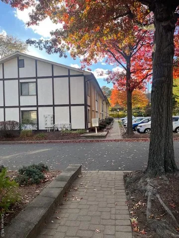 a view of a street with large tree