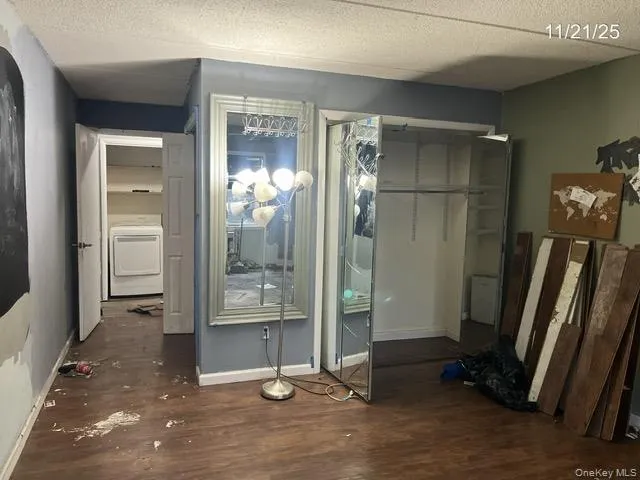 a view of a hallway with a glass door and furniture