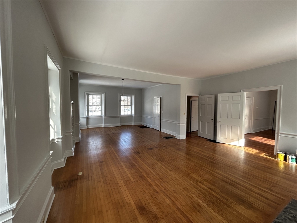 660 High Street Dedham, MA 02026 - Photo 12 of 25 a view of an empty room with wooden floor and a window
