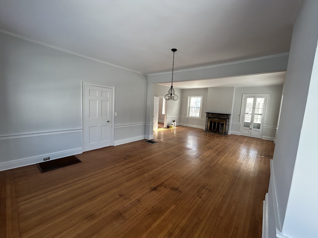 660 High Street Dedham, MA 02026 - Photo 13 of 25 an empty room with wooden floor and fireplace