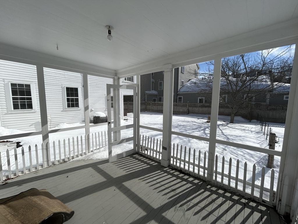 660 High Street Dedham, MA 02026 - Photo 14 of 25 a view of a porch with wooden floor and iron stairs