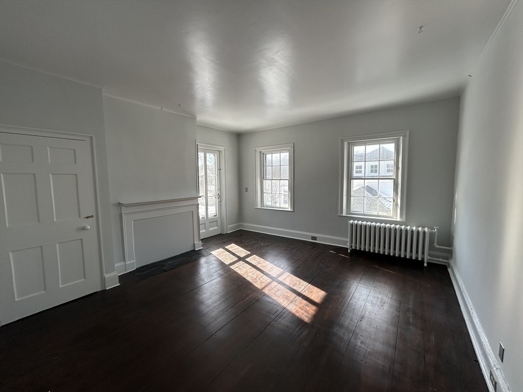 660 High Street Dedham, MA 02026 - Photo 16 of 25 an empty room with wooden floor and windows