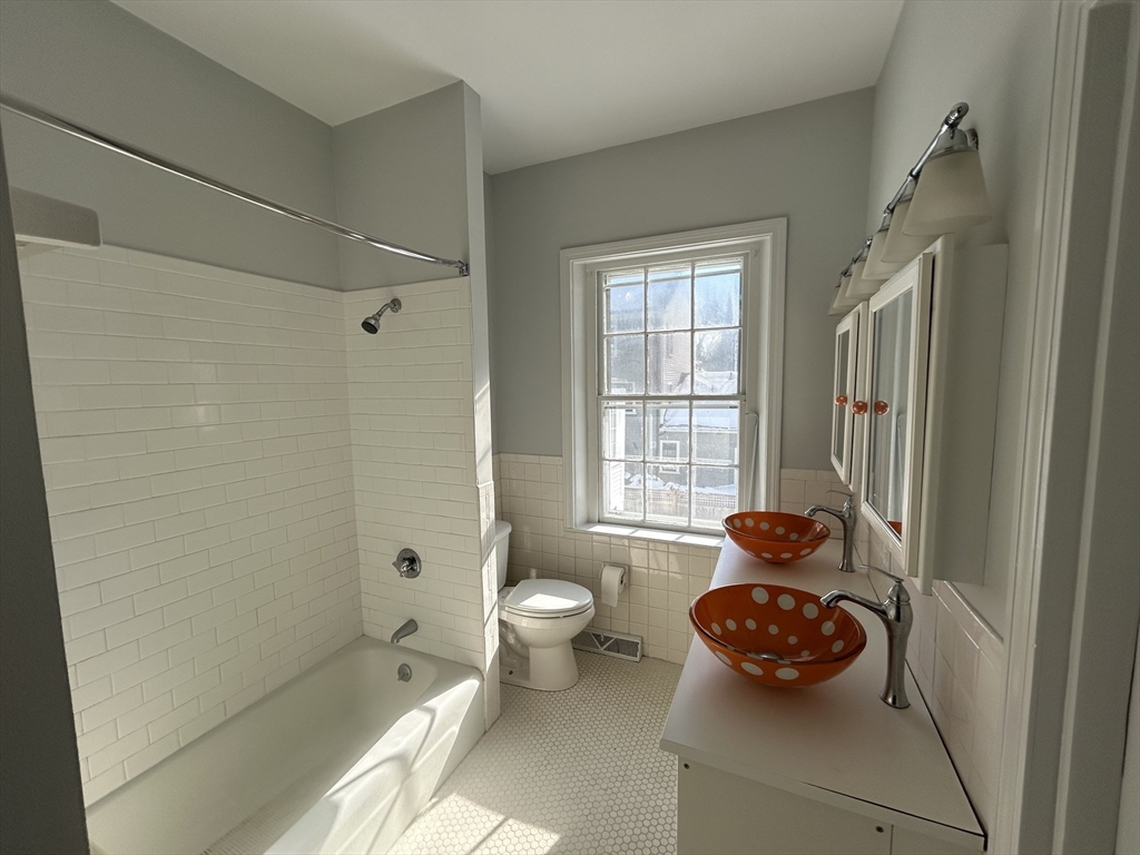 660 High Street Dedham, MA 02026 - Photo 22 of 25 a bathroom with a toilet a sink and shower