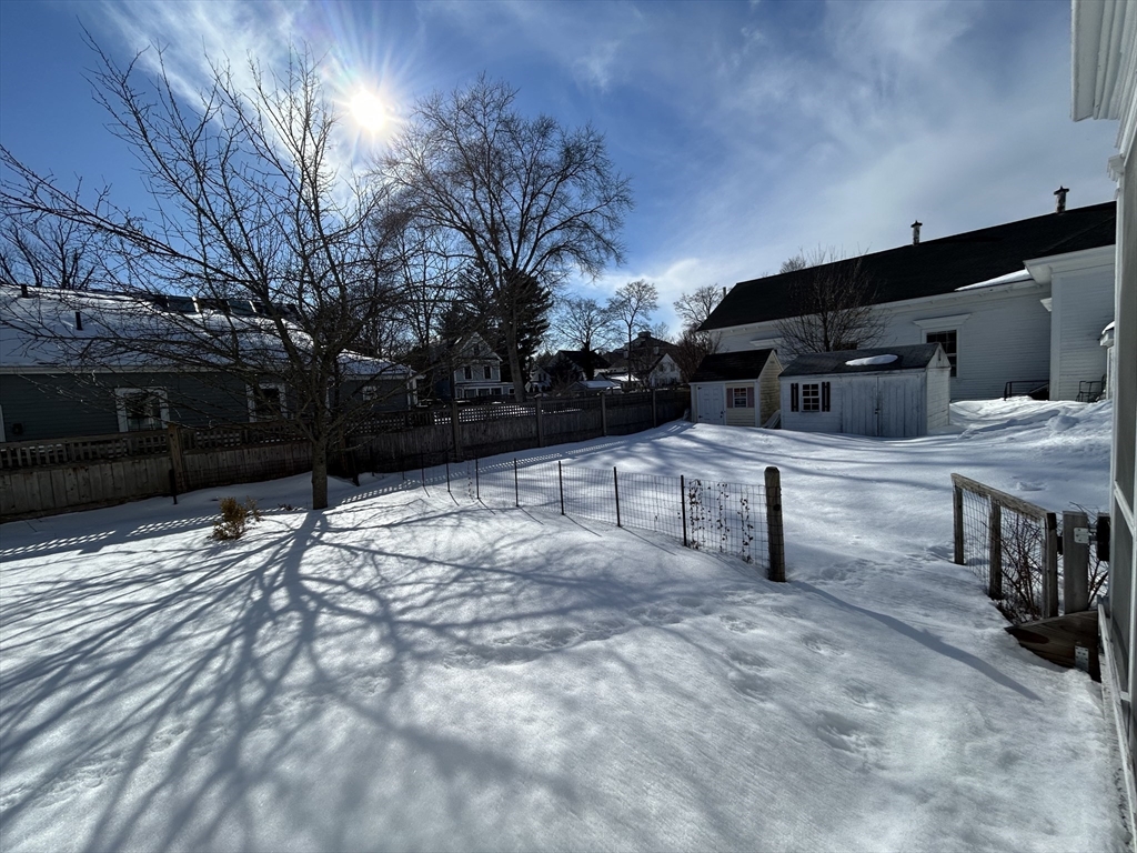 660 High Street Dedham, MA 02026 - Photo 25 of 25 a backyard of a house with table and chairs with wooden fence