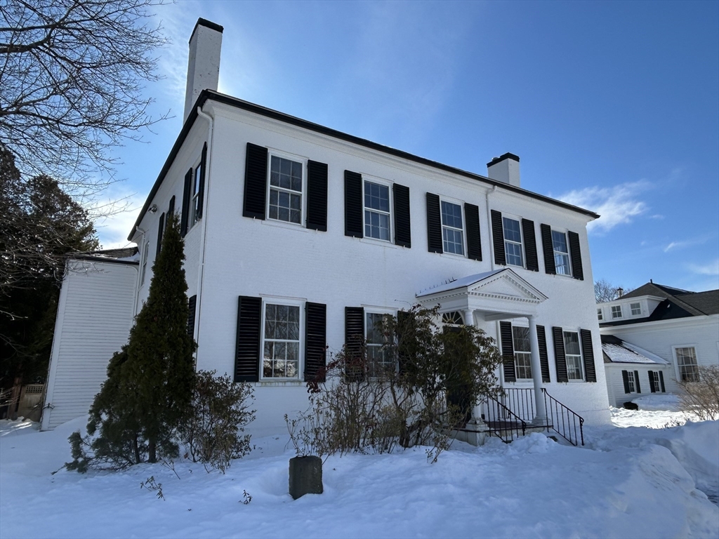 660 High Street Dedham, MA 02026 - Photo 4 of 25 a front view of a house with a yard
