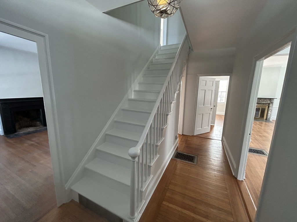 660 High Street Dedham, MA 02026 - Photo 6 of 25 a view of staircase with lots of frames on wall and stairs