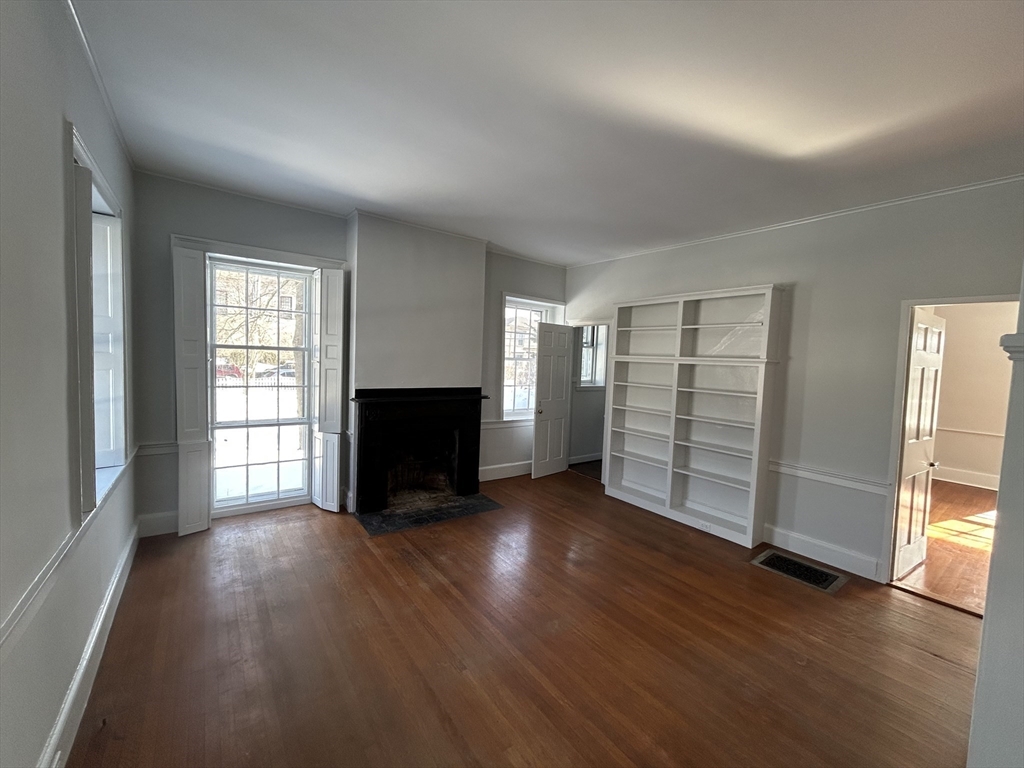660 High Street Dedham, MA 02026 - Photo 7 of 25 an empty room with wooden floor and windows