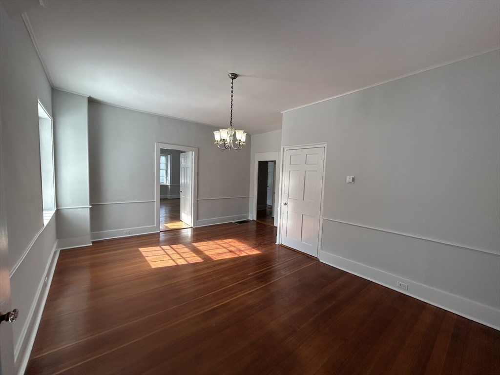 660 High Street Dedham, MA 02026 - Photo 8 of 25 a view of an empty room with window and wooden floor