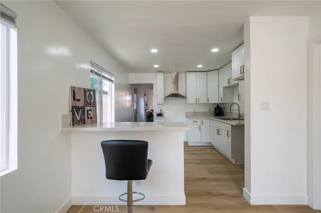 a kitchen with stainless steel appliances granite countertop a refrigerator a sink a stove a microwave and wooden cabinets