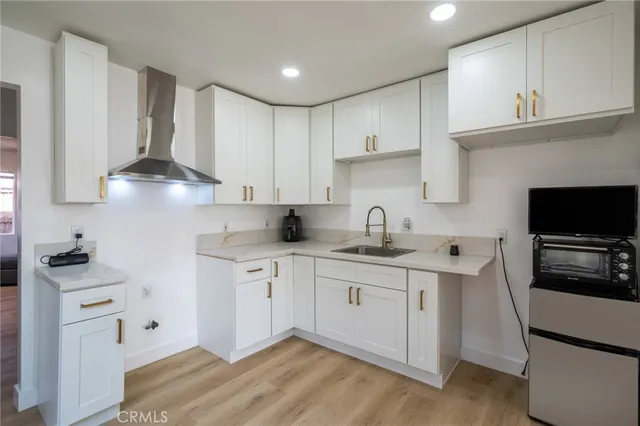 a kitchen with stainless steel appliances a sink stove and cabinets