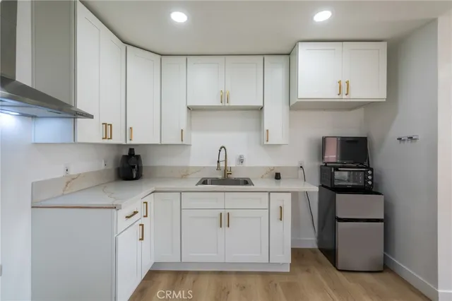 a kitchen with stainless steel appliances granite countertop a sink stove and cabinets