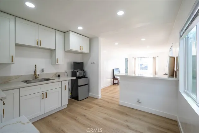 a kitchen with a sink stove and cabinets