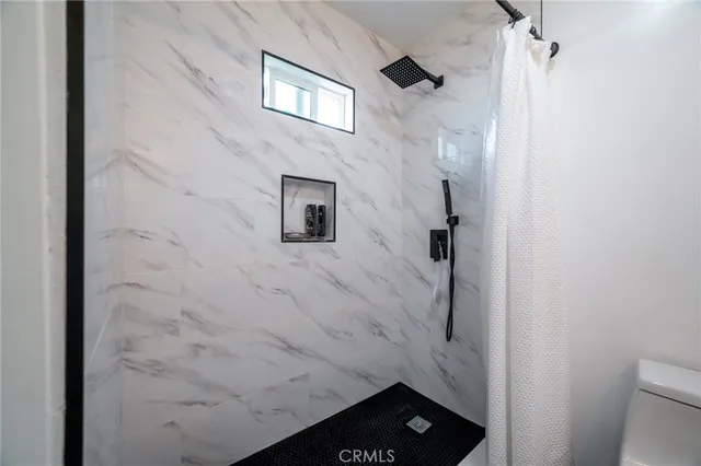 a bathroom with a shower and a toilet