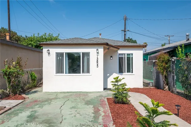 a front view of a house with potted plants