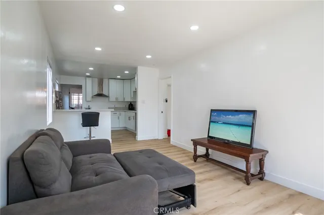 a living room with furniture and kitchen view
