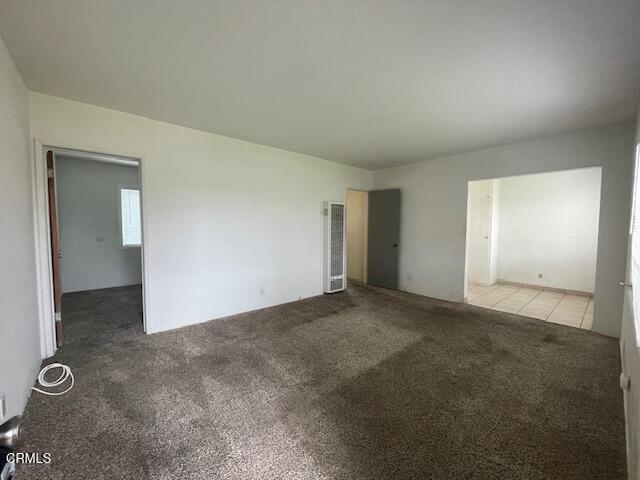 818 Palm Drive, Unit C Oxnard, CA 93030 - Photo 3 of 11 an empty room with windows and entrance to other room