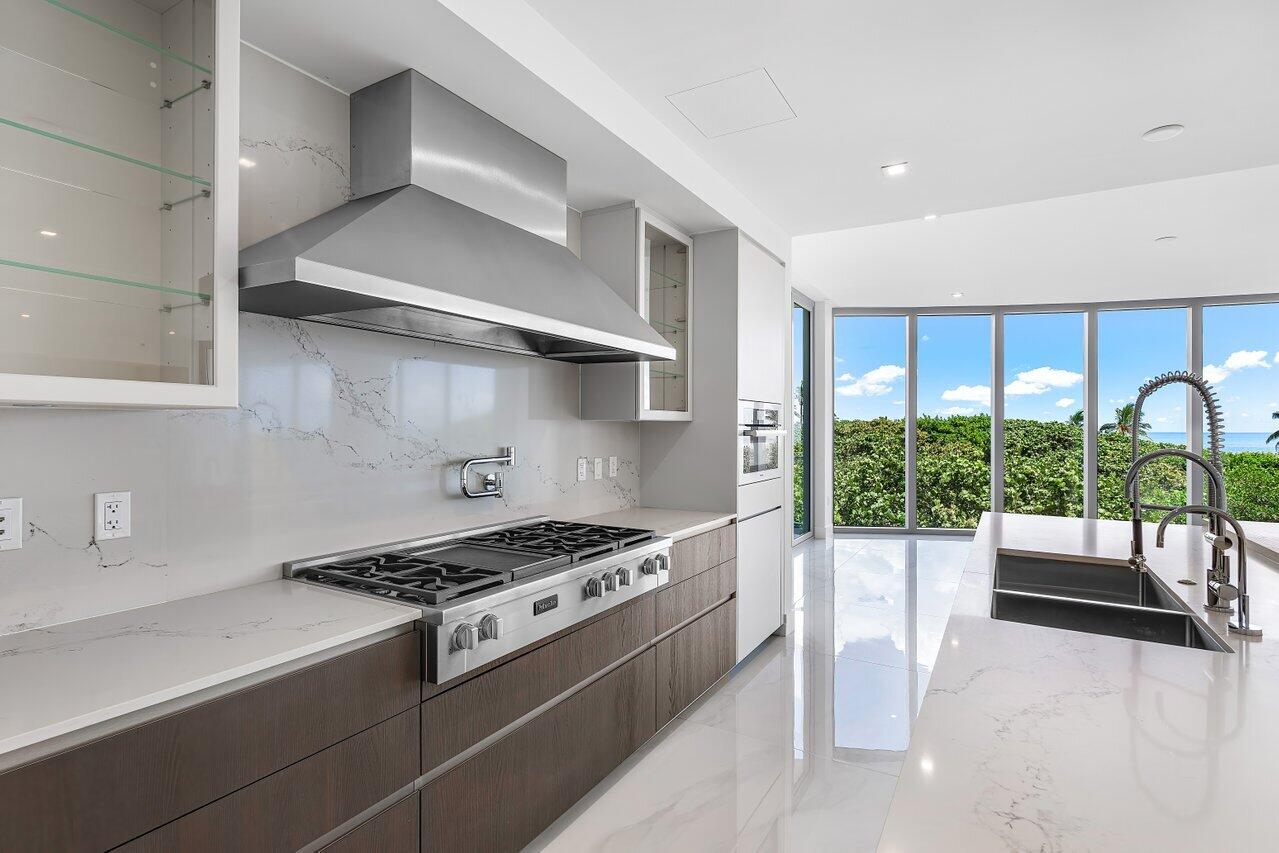 1500 South Beach Road, Unit 301 Tequesta, FL 33469 - Photo 16 of 21 a kitchen with stainless steel appliances granite countertop a stove and a sink