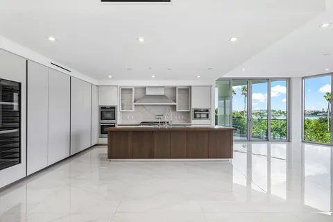 a large kitchen with a large window and stainless steel appliances