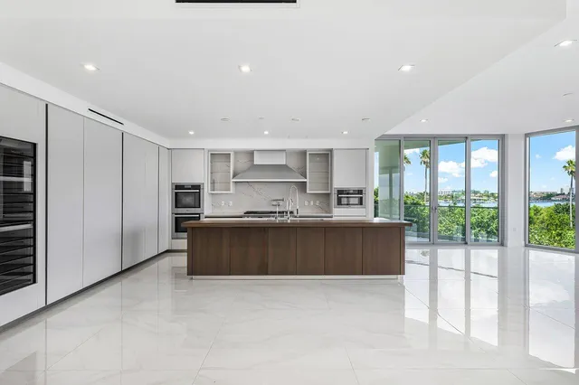 a large kitchen with a large window and stainless steel appliances