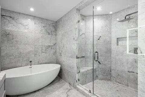 a bathroom with a bathtub and shower
