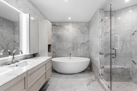 a spacious bathroom with a bathtub and shower