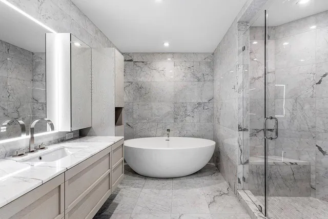 a spacious bathroom with a bathtub and shower