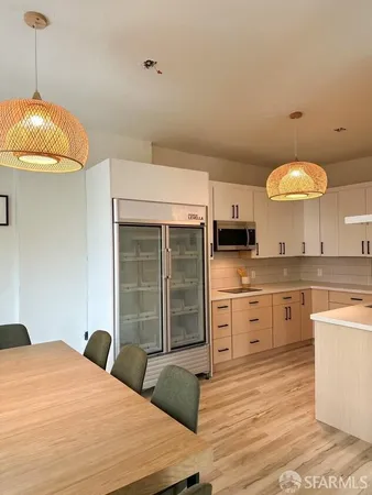 a kitchen with stainless steel appliances granite countertop a sink a stove and cabinets