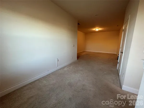 an empty room with a empty space and windows